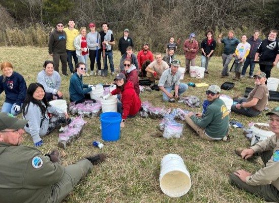 photo of people working to harvest river cane rhizomes